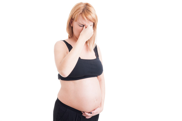 Jonge zwangere vrouw met een hoofdpijn - Foto, afbeelding