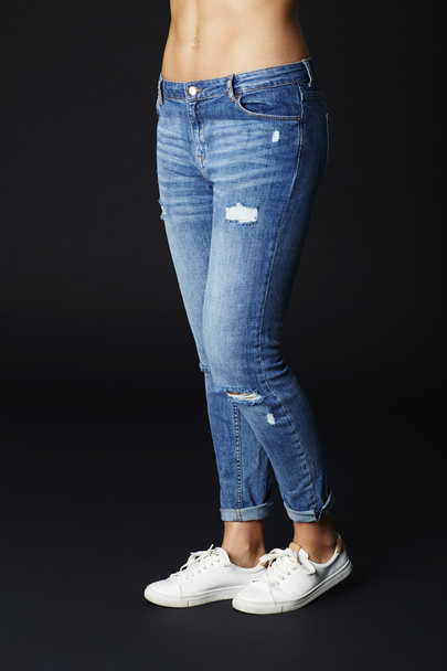 Young woman in jeans and sneakers - Foto, imagen