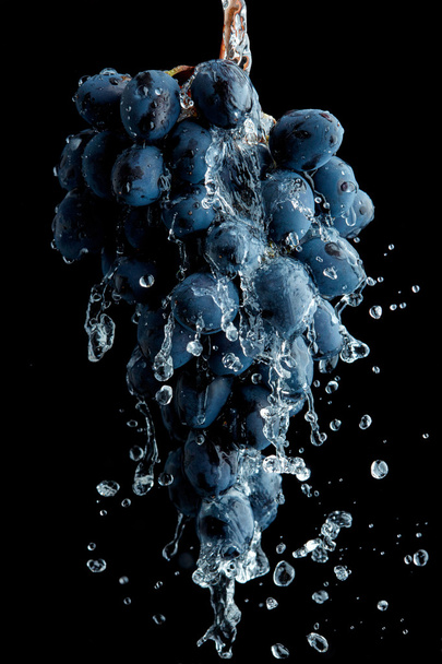 Branch of grapes over black background - Foto, afbeelding