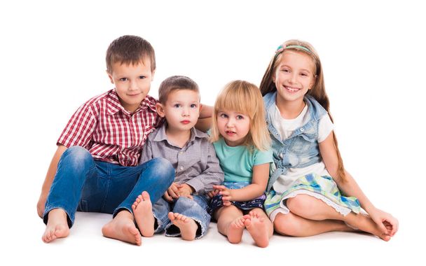 four cute children sitting on the floor - Photo, image