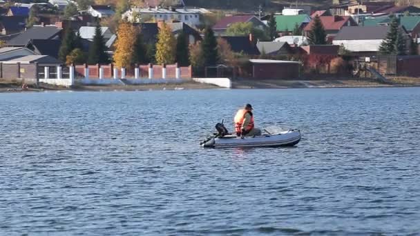A fisherman in a motor boat fishing - Footage, Video