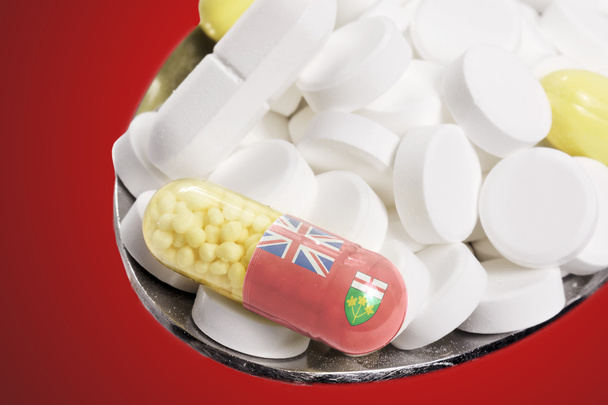 Lžíce plná tabletky a kapsle s flagdesign Ontario - Fotografie, Obrázek