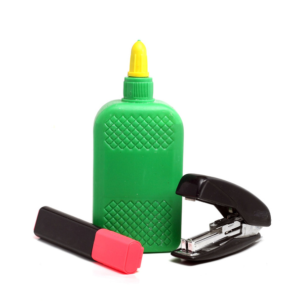 bottle of glue, stepler and a pink marker on a white background - Photo, Image