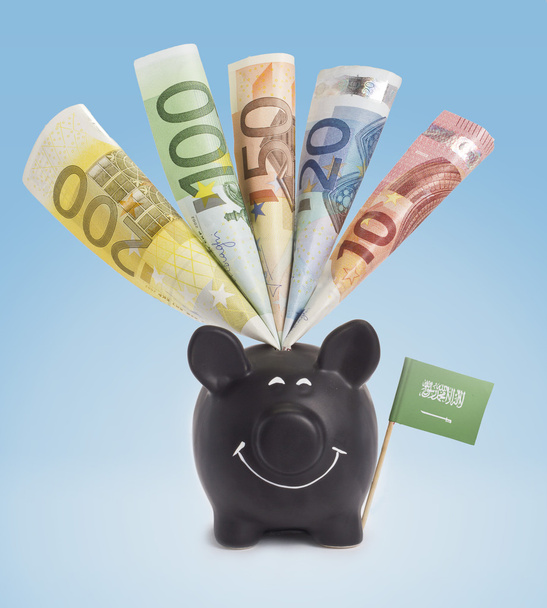 verschiedene europäische Banknoten in einem glücklichen Sparschwein aus Saudi-Arabien. - Foto, Bild