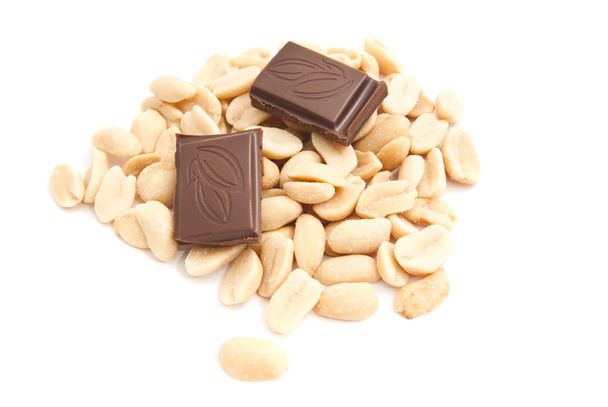 chocolate and peanuts on white - Фото, изображение