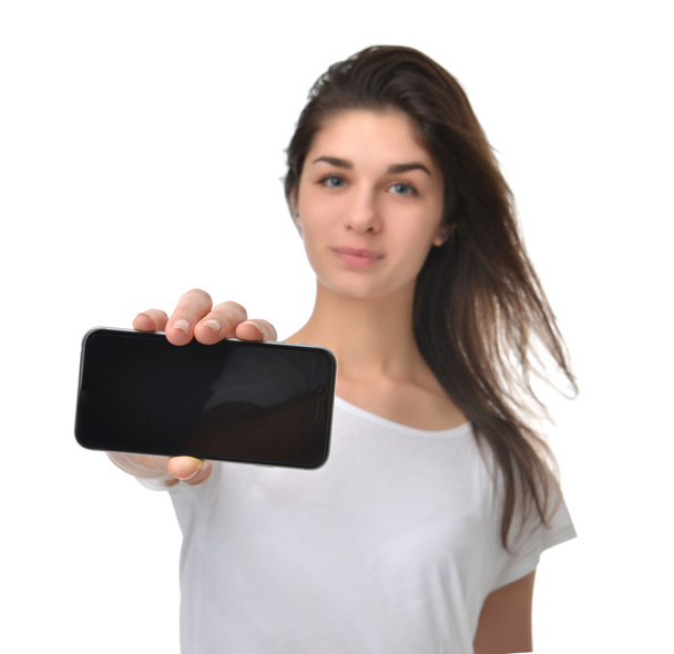 Young woman show display of mobile cell phone with blank screen - Foto, imagen