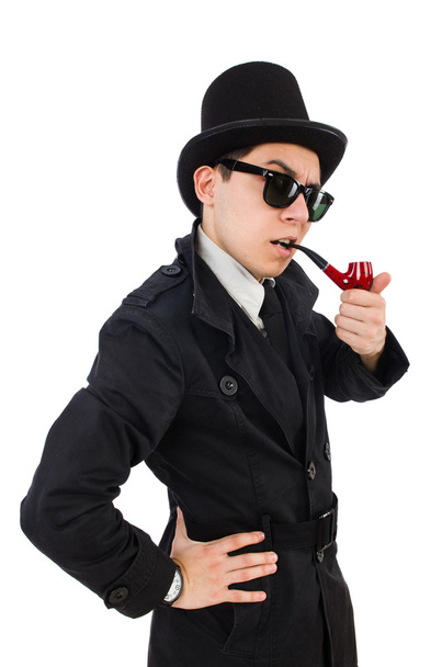 Joven detective con abrigo negro sosteniendo lupa aislada - Foto, imagen