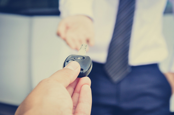 Hand giving car key to a businessman, car sale & rental concepts - Photo, Image