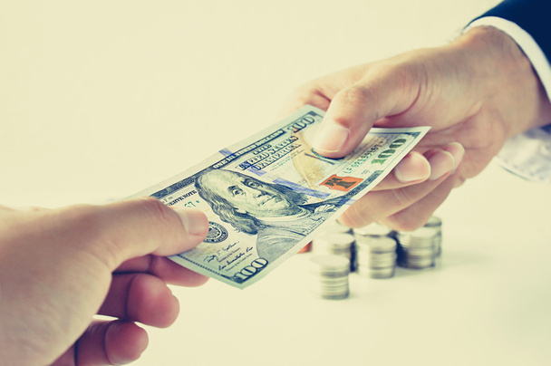 Hands giving & receiving money, 100 US dollars (USD) bill - Фото, зображення