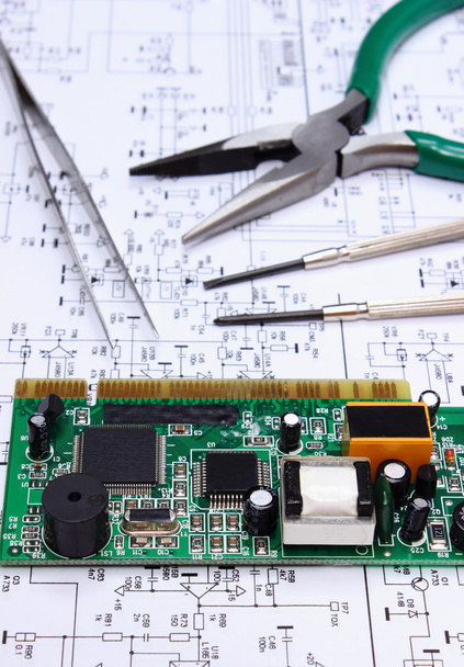 Printed circuit board and precision tools on diagram of electronics, technology - Photo, Image