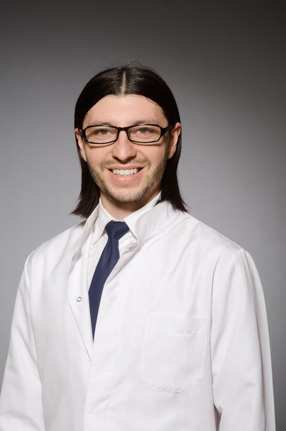 Young physician against gray - Foto, Imagen