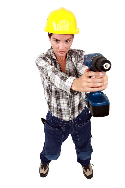 Young woman with a drill - Φωτογραφία, εικόνα