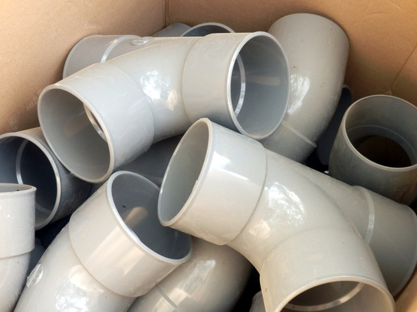 Cardboard box full of drainage pipe joints - Photo, Image