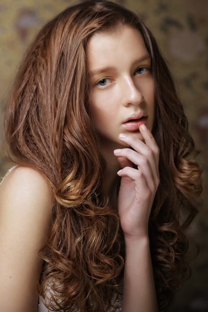 young woman with long curly hair - 写真・画像