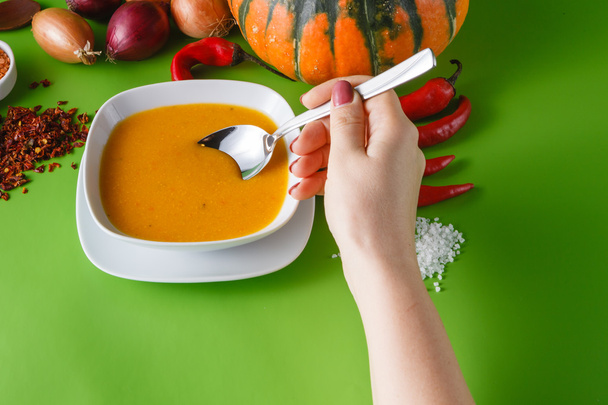 Pumpkin soup with onion and pepper on green shadowless backgroud - 写真・画像