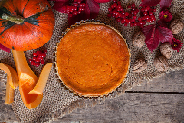 Traditional delicious pumpkin tart pie dessert food  with nuts and fall composition on vintage wooden background. - Φωτογραφία, εικόνα