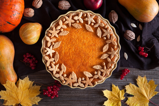 Homemade pumpkin tart pie organic sweet dessert food with various decoration on top. Traditional halloween or thanksgiving day healthy treat. Autumn composition,  vintage wooden background - Foto, afbeelding