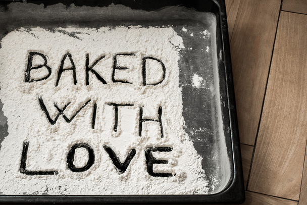 Baked with Love Word Written on Baking Sheet Covered with White Flour - Valokuva, kuva