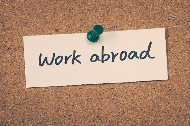 Work abroad note pinned on the bulletin board - Photo, Image