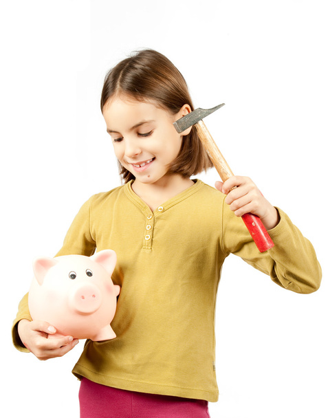 Little girl breaking a piggy bank - Фото, зображення