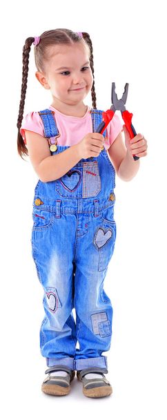 Cute little girl in overall with pliers - Foto, afbeelding