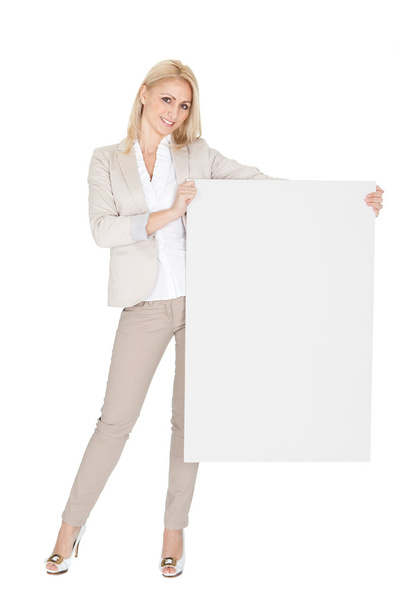 Cheerful businesswomen presenting empty board - Zdjęcie, obraz