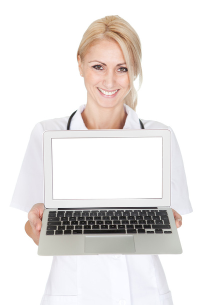 Smiling medical doctor woman presenting laptop - Valokuva, kuva