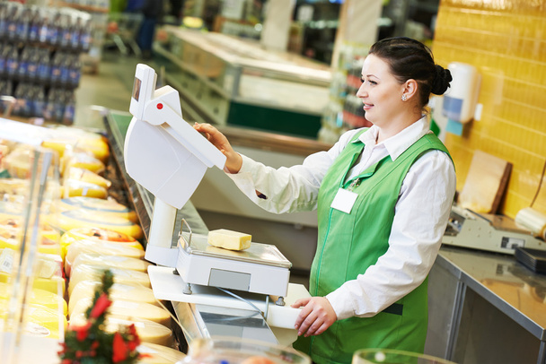saleswoman in supermarket shop - Foto, Imagen