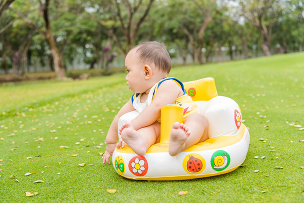 Outdoor portrait of Asian baby boy playing sitting and crawling - Foto, immagini