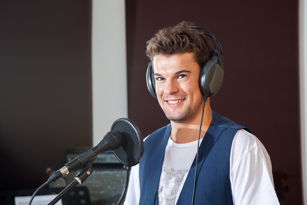 Smiling Young Male Singer In Recording Studio - Foto, afbeelding