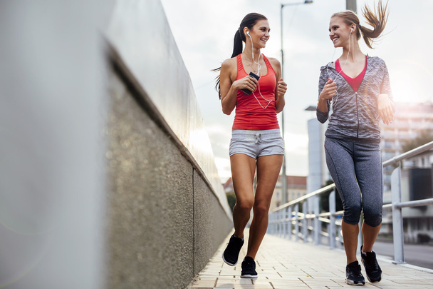 Two women exercising by jogging - Foto, Imagem