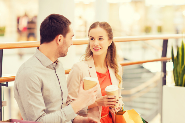happy couple with shopping bags drinking coffee - Photo, image