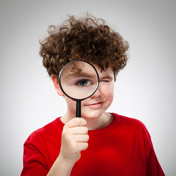 Boy looking through magnifying glass - Fotó, kép