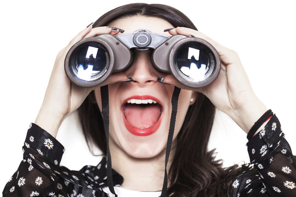 Distorted girl looking through binoculars - Foto, imagen