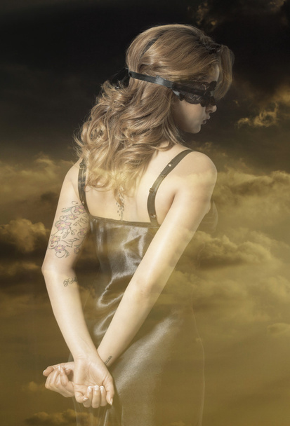 Double exposure of blindfold woman back portrait and orange suns - 写真・画像