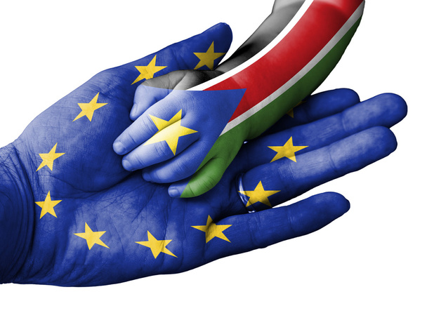 Adult man holding a baby hand with European Union and South Sudan flags overlaid. Isolated on white - Photo, Image