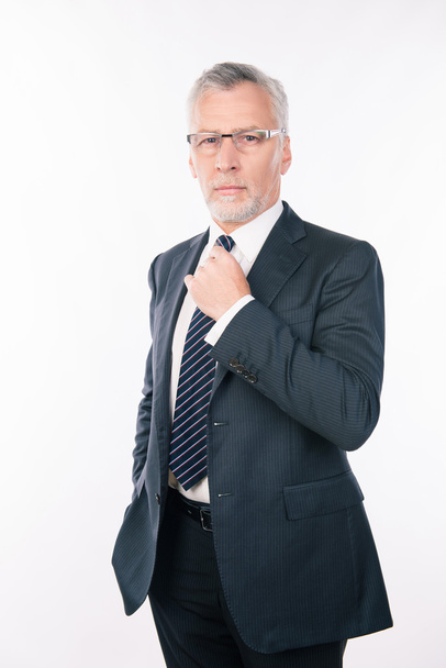 handsome old businessman in a business suit on a white backgroun - 写真・画像