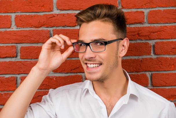 subtle handsome man holding his glasses - Photo, image