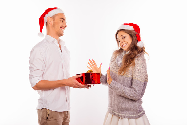 handsome young man giving a Christmas present to his girlfriend - Foto, imagen