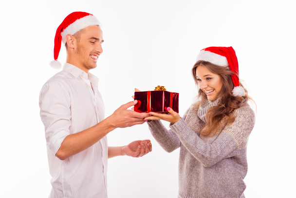 handsome young man giving a Christmas present to his lovely girl - Foto, immagini