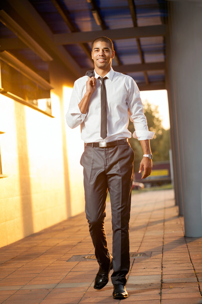 Successful businessman walk happy into the sunset - Photo, Image