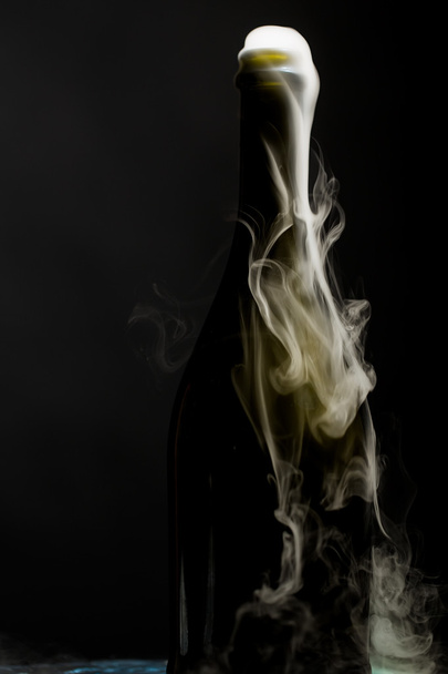 Champagne bottle with smoke - Фото, зображення