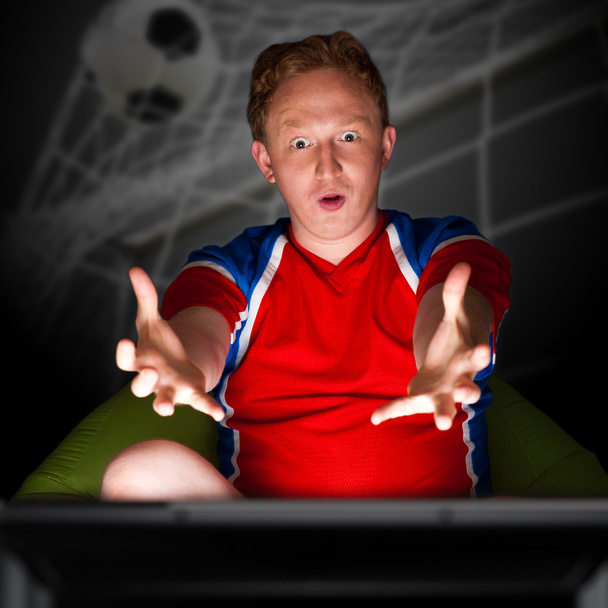 Closeup portrait of young man wearing sportswear fan of football - Fotó, kép
