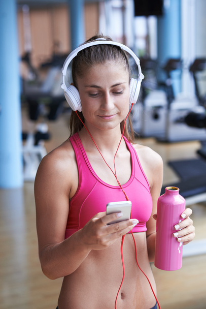 woman with headphones in fitness gym - 写真・画像
