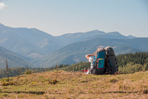Dos turistas disfrutan del paisaje en la cima de la montaña
 - Foto, imagen