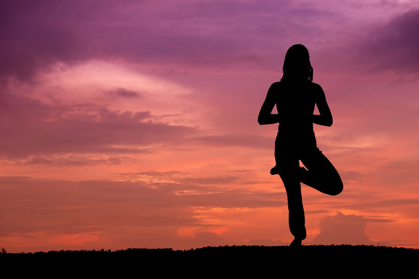 Silhouette of a beautiful Yoga woman - Foto, Bild