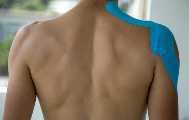 Adhesive bandage on shoulder - Фото, изображение