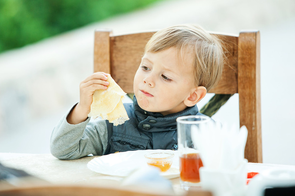eating baby boy at park - Фото, изображение
