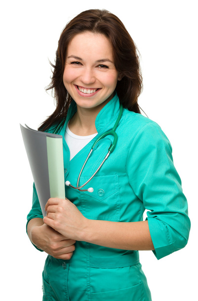 Young attractive woman wearing a doctor uniform - Фото, изображение