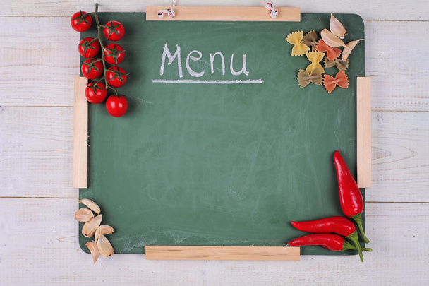 Menu chalkboard on white rustic wooden table decorated with  Colorful  Vegetables, Tomatos, ped pepper. Blank background for copy space - Photo, image